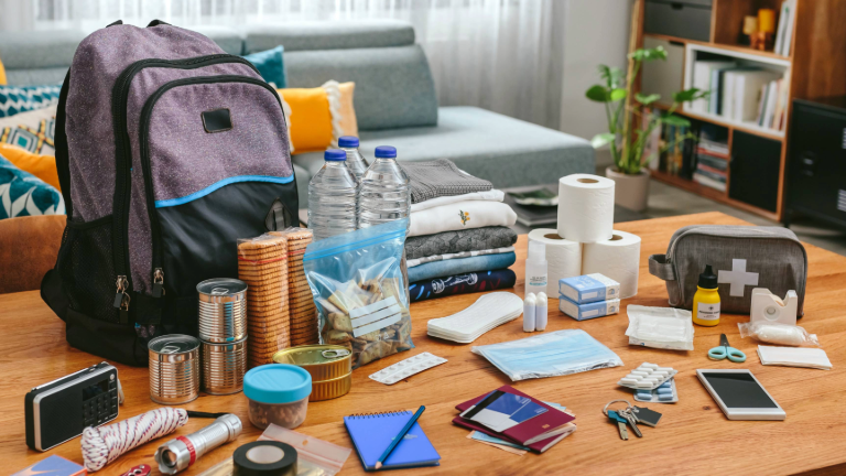 Contents of an emergency kit organized on a table before being put into its designated bag.