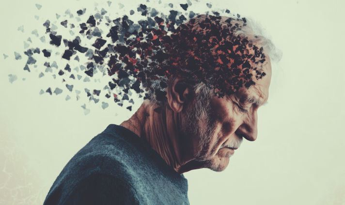 An elderly man looking sad as his brain breaks off into fragments.