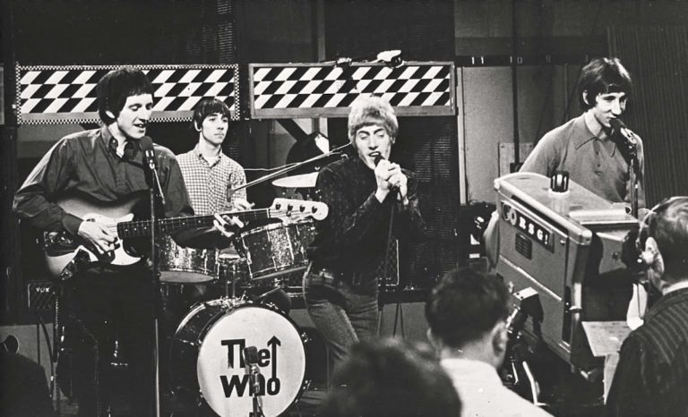 Black and white image of The Who performing live.