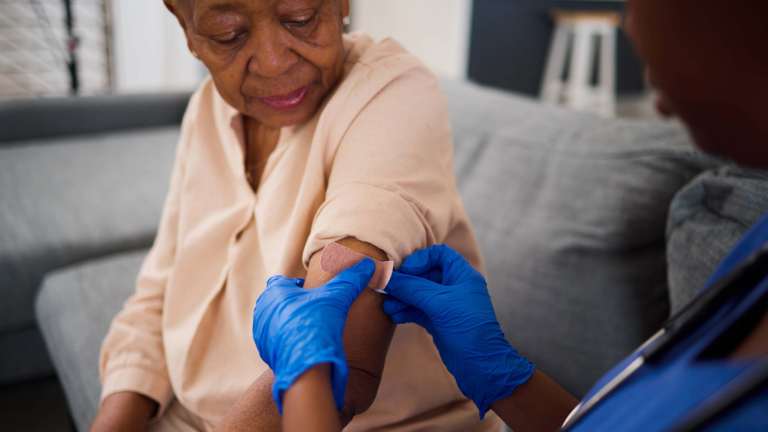 Elderly woman receiving healthcare.