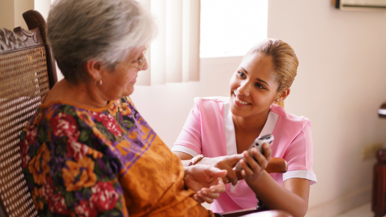 A care giver attending to an elderly patient